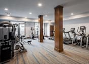 Thumbnail 31 of 47 - A gym with a variety of equipment including treadmills, weights, and exercise machines at The Edison at Spirit, Lakeville, MN