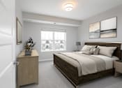 Thumbnail 11 of 24 - A bedroom with a large bed and a wooden nightstand at The Edison at Woodbury, Woodbury Minnesota