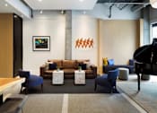 Thumbnail 8 of 100 - Brown sofa and blue chair at The M on Hennepin, Minneapolis, Minnesota