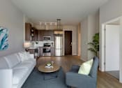 Thumbnail 24 of 100 - white sofa and grey chair in living area at The M on Hennepin, Minneapolis, MN