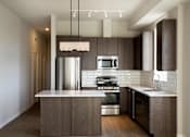 Thumbnail 84 of 100 - Kitchen with brown cabinets at The M on Hennepin, Minneapolis, MN, 55414