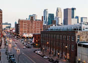 Thumbnail 2 of 47 - A city street with cars and buildings at The Redwell Apartments, Minneapolis, MN
