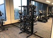 Thumbnail 7 of 47 - A gym with a variety of equipment including treadmills and weights at The Redwell Apartments, Minneapolis, 55401