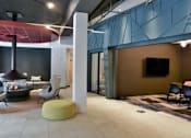 Thumbnail 10 of 47 - A modern living room with a fireplace and a television at The Redwell Apartments, Minnesota 55401