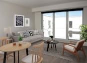 Thumbnail 15 of 47 - A living room with a grey couch, a wooden table, and a chair at The Redwell Apartments, Minneapolis, Minnesota