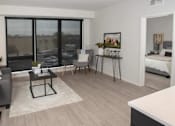 Thumbnail 19 of 47 - A living room with a black coffee table and a grey sofa at The Redwell Apartments, Minneapolis, MN 55401