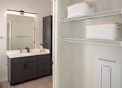 Thumbnail 35 of 47 - A bathroom with a vanity and a medicine cabinet at The Redwell Apartments, Minneapolis, Minnesota