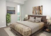 Thumbnail 11 of 54 - A bedroom with a large bed and a painting on the wall.