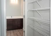 Thumbnail 27 of 54 - A white bathroom with a walk in closet.