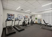 Thumbnail 28 of 54 - A gym with treadmills, exercise bikes, and other equipment.