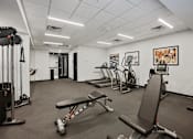 Thumbnail 29 of 54 - A gym with a variety of equipment including a leg press machine.