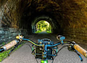 Thumbnail 35 of 54 - A bicycle is parked in a tunnel.