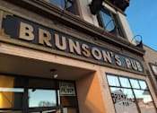 Thumbnail 43 of 54 - The front of a pub named Brunson's Pub is shown.