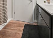 Thumbnail 8 of 54 - A white door is in a room with a black rug and wooden flooring.
