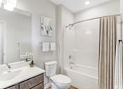 Thumbnail 6 of 36 - A White Bathroom at Peregrine Apartments, Minneapolis, Minnesota