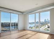 Thumbnail 15 of 36 - Living Room with Oversized Windows at Peregrine Apartments, Minnesota, 55411
