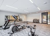 Thumbnail 32 of 36 - A Gym with Elliptical Machines at Peregrine Apartments, Minnesota