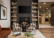 Thumbnail 9 of 55 - A living room with a fireplace and a television mounted above it.
