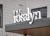 Thumbnail 51 of 55 - A white sign with black lettering that reads "The Roslyn".