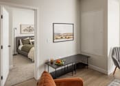 Thumbnail 5 of 55 - A living room with a bed, a couch, a chair, and a painting on the wall.