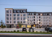 Thumbnail 68 of 70 - A large building with a parking lot in front of it.