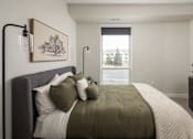 Thumbnail 6 of 55 - A bedroom with a large bed and a painting on the wall.