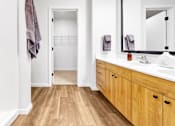 Thumbnail 35 of 113 - A bathroom with wooden floors and white walls.