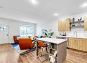 Thumbnail 31 of 113 - A modern kitchen with wooden cabinets and a white backsplash.