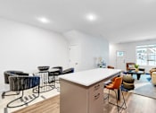Thumbnail 33 of 113 - A modern kitchen with a white countertop and a large island.