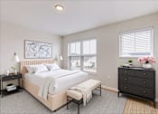 Thumbnail 51 of 52 - A bedroom with a large bed, a bench, and a dresser.