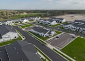 Thumbnail 107 of 113 - A bird's eye view of a housing complex with multiple houses and a parking lot.
