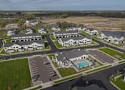 Thumbnail 99 of 113 - A bird's eye view of a residential complex with a swimming pool.
