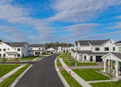 Thumbnail 108 of 113 - A row of houses with a road in between.