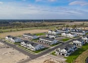 Thumbnail 101 of 113 - A bird's eye view of a residential area with houses and a river.