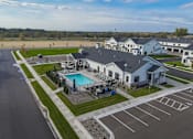 Thumbnail 93 of 113 - A large white building with a pool in front of it.