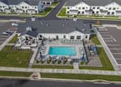 Thumbnail 95 of 113 - A large building with a pool in front of it.