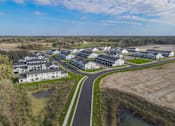Thumbnail 105 of 113 - A bird's eye view of a housing complex with a winding road.