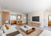 Thumbnail 15 of 49 - A modern living room with a white sofa and a wooden coffee table.