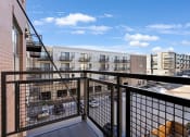 Thumbnail 68 of 104 - a balcony with a view of a city and a blue sky