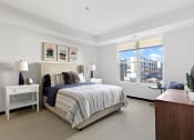 Thumbnail 66 of 104 - a bedroom with a bed and a large window