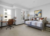 Thumbnail 64 of 104 - a bedroom with a bed and a desk with a chair