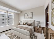 Thumbnail 42 of 104 - A bedroom with a large bed and a chair.