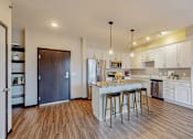Thumbnail 39 of 104 - A kitchen with a white countertop and a bar stool.