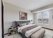 Thumbnail 45 of 104 - A bedroom with a large bed and a window overlooking a snowy landscape.