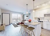Thumbnail 43 of 104 - A kitchen with white cabinets and a marble countertop.