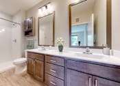 Thumbnail 52 of 91 - a bathroom with a toilet and a sink and a mirror at The Morrison, Rosemount Minnesota