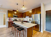 Thumbnail 49 of 91 - a kitchen with a large island with three stools at The Morrison, Minnesota