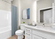 Thumbnail 57 of 123 - A white bathroom with a toilet, sink, and shower.