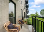 Thumbnail 5 of 64 - the reserve at city center spacious balcony with wicker chairs