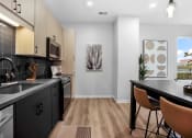 Thumbnail 3 of 64 - an open kitchen and dining room with a table and chairs